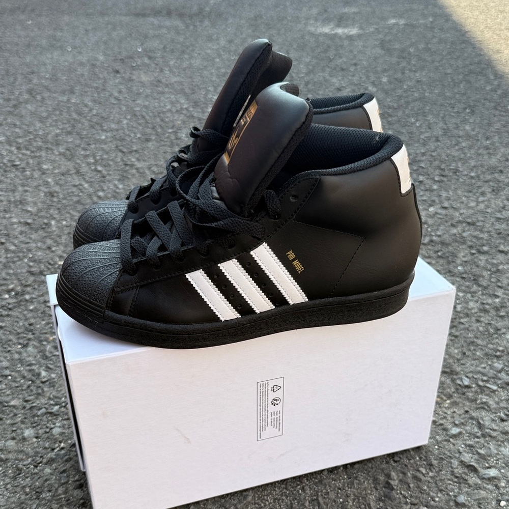 Adidas Black and White High-Tops with Gold Accents